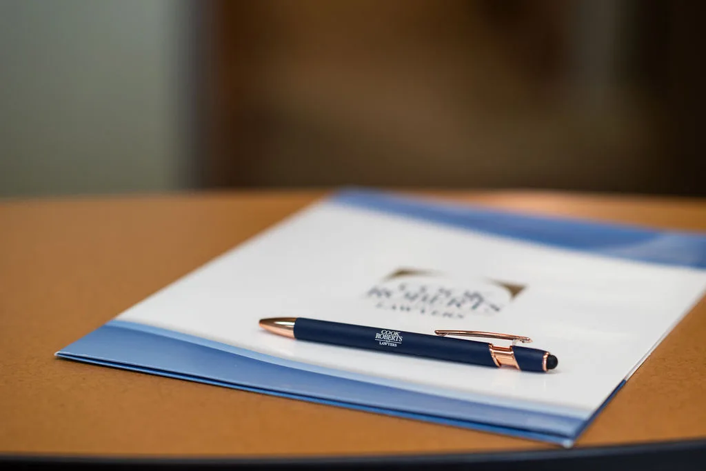 cook roberts LLP pen and paper on a desk